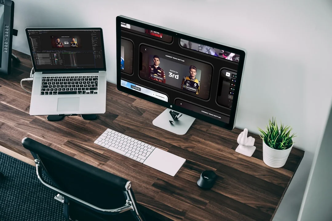 Stylish and efficient workspace with multiple monitors, laptop, and smartphone, showcasing a web design project.